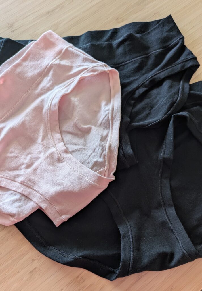 Three cotton hipster underwears from Target one in pink and two in black. 