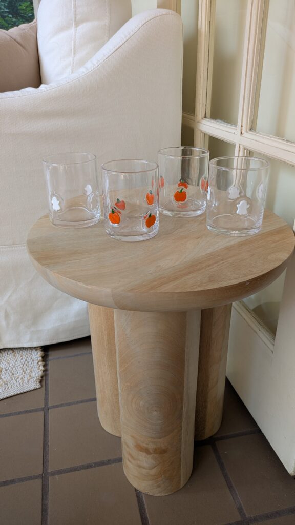 Walmart Thyme & Table Halloween glassware set in the icon's pumpkin and ghost shapes on a side table. 