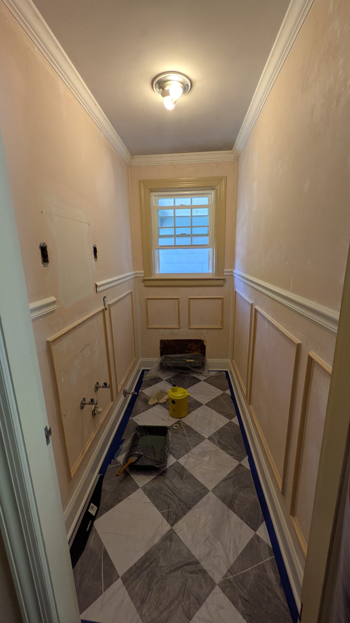 Half bathroom DIY renovation, walls stripped removed wallpaer, wainscoting trim wall treatmant and faux marble checkered tiles.